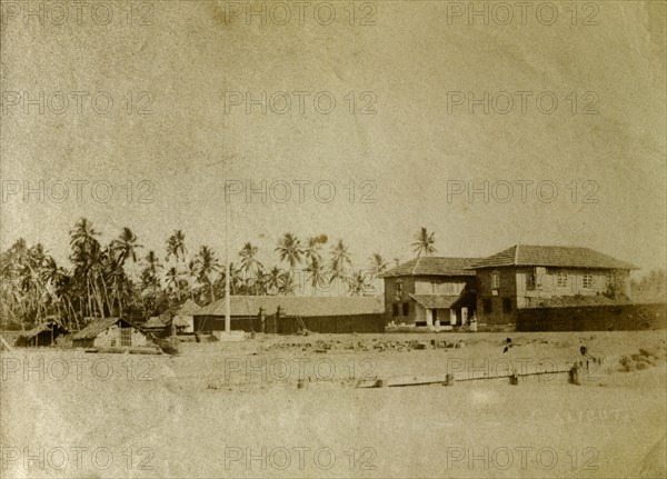 Custom House, India. A Kerala Custom House surrounded by palm trees on the beach. Calicut, India, circa 1910. Calicut, Kerala, India, Southern Asia, Asia.
