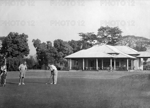 Playing golf, Rangoon. Golfers practice their putts outside the newly opened club house at the Rangoon Golf Club. Rangoon (Yangon), Burma (Myanmar), circa 1952. Yangon, Yangon, Burma (Myanmar), South East Asia, Asia.