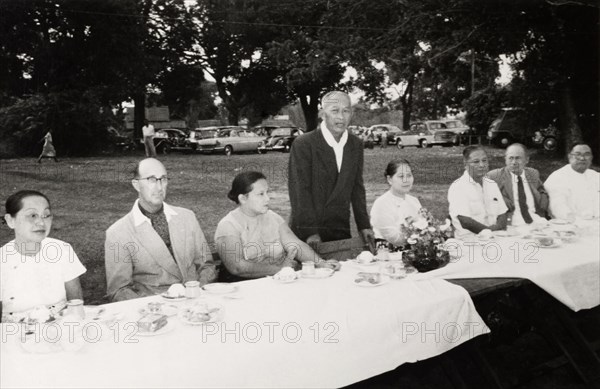 Speech at Rangoon Golf Club. A Burmese man stands to deliver a speech for an audience at the Rangoon Golf Club. Rangoon (Yangon), Burma (Myanmar), circa 1952. Yangon, Yangon, Burma (Myanmar), South East Asia, Asia.