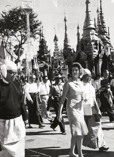 Princess Alexandra of Kent at Shwe Dagon Pagoda. Princess Alexandra of Kent walks with a procession of people during a visit to Shwe Dagon Pagoda. Rangoon (Yangon), Burma (Myanmar), circa 1960. Yangon, Yangon, Burma (Myanmar), South East Asia, Asia.
