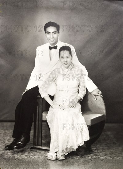 Portrait of a married Burmese couple. Studio portrait of a married Burmese couple, Mrs and Mrs Nyun Hlaing, dressed in formal, Western-style clothes. Probably Burma (Myanmar), circa 1960. Burma (Myanmar), South East Asia, Asia.