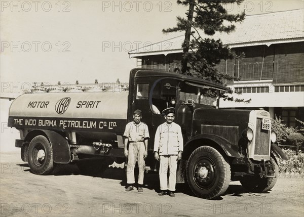 Indo-Burma Petroleum Company tanker. Two uniformed Burmese workers pose for a photograph in front of an Indo-Burma Petroleum Company petrol tanker. Burma (Myanmar), circa 1942. Burma (Myanmar), South East Asia, Asia.