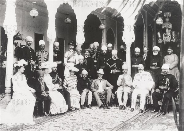 British and Indian officials at the Maharajah's palace. Indian and British officials pose for a group portrait inside a room at Maharajah Peishkar's palace. Guests include Marquess Curzon of Kedleston (1859-1925), Viceroy of India between 1899 and 1905, and Mahbub Ali Khan (1869-1911), Nizam of Hyderabad State. Hyderabad, India, 1902. Hyderabad, Andhra Pradesh, India, Southern Asia, Asia.