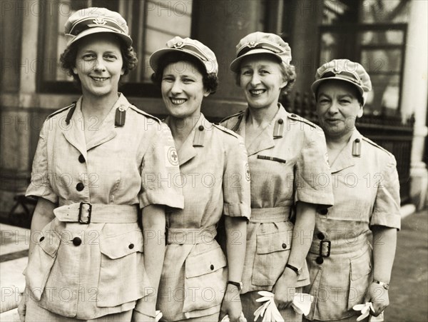 A British Red Cross team bound for Kenya. Four women in the British Red Cross line up for a group portrait on their last day in London before flying out to Kenya via Egypt. London, England, April 1954. London, London, City of, England (United Kingdom), Western Europe, Europe .