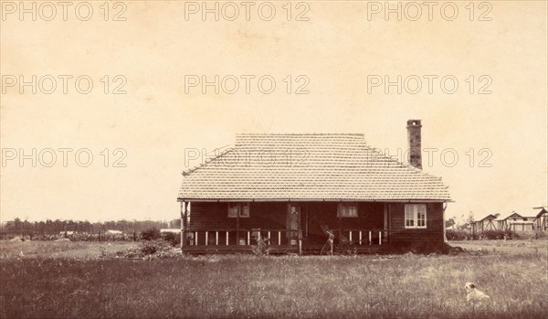 Charles Bungey's house. This timber-framed house was built for Charles Bungey, a training officer with the Kenyan Public Works Department, by the apprentices of his department in March 1922. The apprentices' quarters can be seen in the background on the right. Nakuru, Kenya, 1922. Nakuru, Rift Valley, Kenya, Eastern Africa, Africa.
