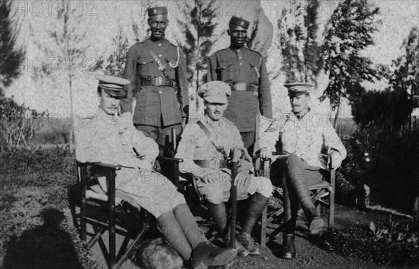 Senior staff from Nairobi jail. Senior staff from Nairobi jail pose for the camera. Head jailor, H A Stanton, is pictured seated in the centre surrounded by two European and two African head assistants. Nairobi, British East Africa (Kenya), 1917. Nairobi, Nairobi Area, Kenya, Eastern Africa, Africa.