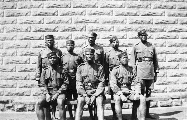 Warders at Nairobi Jail. Group portrait of eight African jail warders wearing uniform. Nairobi, British East Africa (Kenya), 1917. Nairobi, Nairobi Area, Kenya, Eastern Africa, Africa.