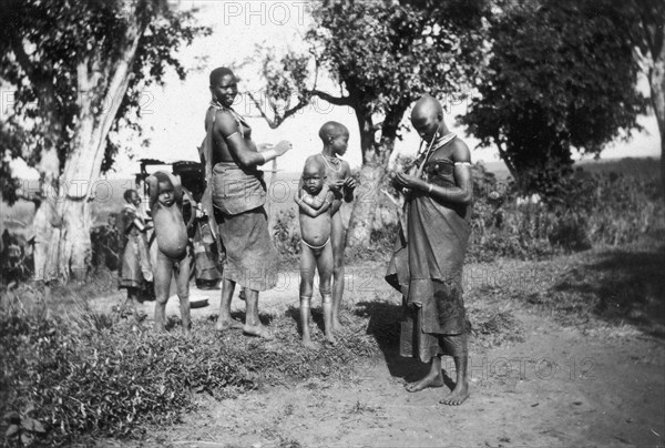 Nandi mothers and children. Nandi mothers pictured with their children in a rural setting. Near Kapsabet, Kenya, circa 1928. Kapsabet, Rift Valley, Kenya, Eastern Africa, Africa.