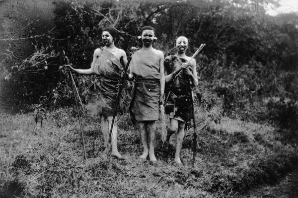 Nandi youths during circumcision rites. Three Nandi youths in seclusion during their circumcision rites. The boys' faces are painted and they hold bows and arrows. Kapsabet, Kenya, February 1928. Kapsabet, Rift Valley, Kenya, Eastern Africa, Africa.