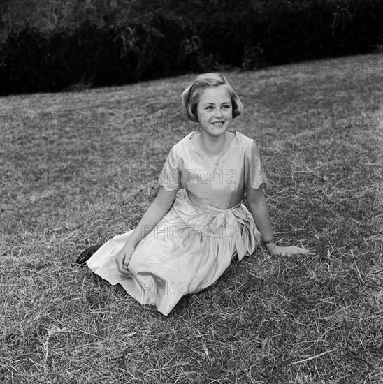 Neville Vincent's daughter. Portrait of Neville Vincent's daughter wearing a satin dress with a sash tied around the waist. Kenya, 28 August 1955. Kenya, Eastern Africa, Africa.