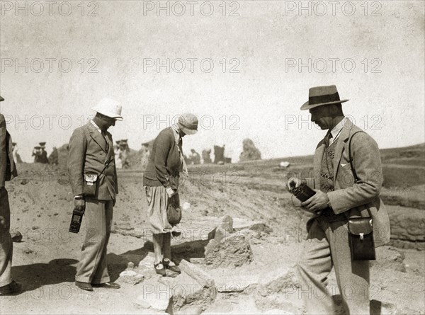 Archaeological excavation. Two European men with cameras or recording equipment accompany a woman on a visit by the Governor General to the archaeological excavation of a twelfth dynasty fort. North East Africa, 1932., Northern Africa, Africa.