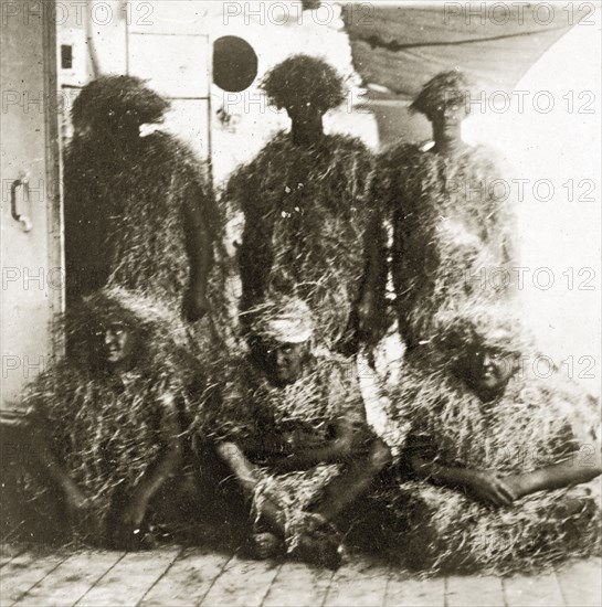 King Neptune's bears. Five crew members aboard ship are covered in straw, disguised as King Neptune's bears for a 'crossing the line' ceremony. Atlantic Ocean south of Sierra Leone, 14-22 December 1923., Western Africa, Africa.