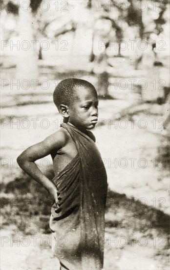 Swahili boy. Portrait of a young Swahili boy standing with his hands on his hips. Zanzibar (Tanzania), 12-17 January 1924., Zanzibar Urban/West, Tanzania, Eastern Africa, Africa.