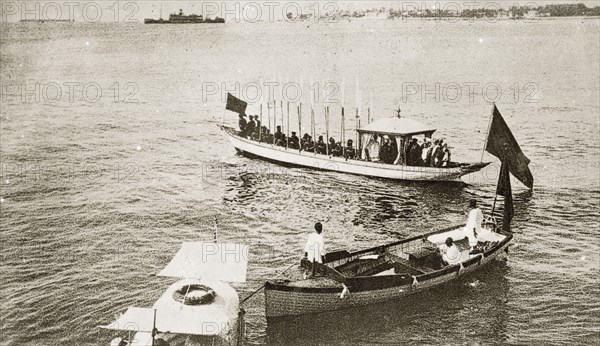 Sultans and Sheiks aboard a barge. A Sultan and Sheiks aboard an official state barge decorated with flags. Zanzibar (Tanzania), 12-17 January 1924., Zanzibar Urban/West, Tanzania, Eastern Africa, Africa.