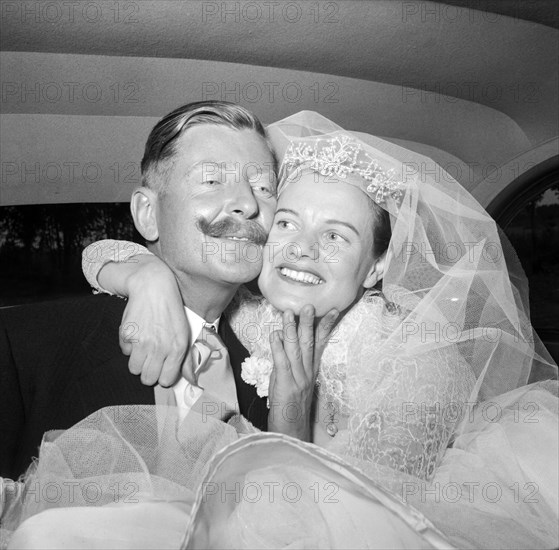 The Williams and McLaughlan couple. The newlywed Williams and McLaughlin couple pictured in the back of their wedding car shortly after their marriage ceremony. Kenya, 22 August 1956. Kenya, Eastern Africa, Africa.
