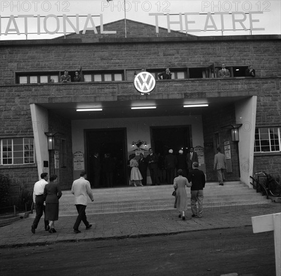 Volkswagen exhibition at the national theatre. Guests arrive for the opening of a Volkswagen exhibition being hosted inside the national theatre building. Nairobi, Kenya, 22 August 1956. Nairobi, Nairobi Area, Kenya, Eastern Africa, Africa.