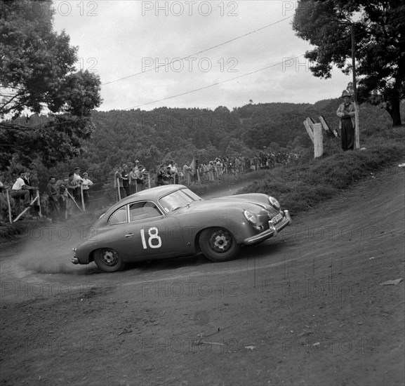 Hofman takes a corner. A Porsche driven by Hofman skids around the corner in event number thirteen at the Brackenhurst Hill Climb. Limuru, Kenya, 30 September 1956. Limuru, Central (Kenya), Kenya, Eastern Africa, Africa.