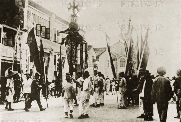 Chinese New Year procession. Banners and flags are paraded through town in celebration of the Chinese New Year. Penang, British Malaya (Malaysia), 5 February 1924., Penang, Malaysia, South East Asia, Asia.