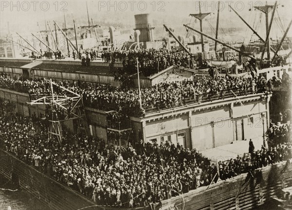 Leaving party. Hoards of people crowd together on every available ledge to wave goodbye to the British Special Service Squadron as they depart from the harbourside. Hobart, Tasmania, 27 March-3 April 1924. Hobart, Tasmania, Australia, Australia, Oceania.