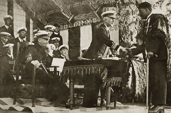 Rear Admiral Brand shakes hands. Rear Admiral Sir Hubert Brand shakes hands with a Maori man identified as 'Mr Harris' at a presentation ceremony. Probably Rotorua, New Zealand, 10-17 May 1924. Rotorua, Bay of Plenty, New Zealand, New Zealand, Oceania.