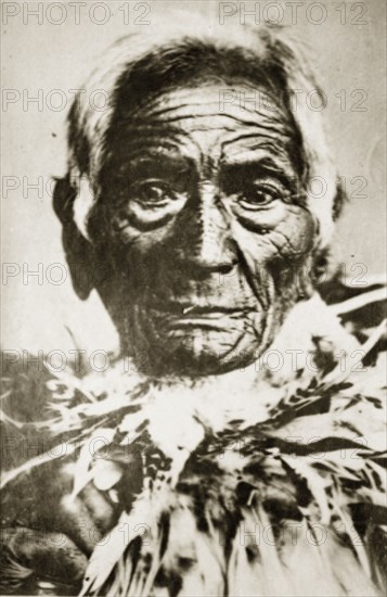 Portrait of a Maori chief. Portrait of an elderly Maori man wearing a ring of feathers around his neck. Probably Roturua, New Zealand, 10-17 May 1924. Rotorua, Bay of Plenty, New Zealand, New Zealand, Oceania.