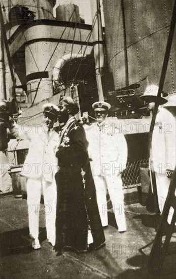 Guided tour of HMS Hood. Sir Laurence Field and Captain John Thurn, commanding aboard HMS Hood, give a guided tour of the ship's deck to a Sultan. Zanzibar (Tanzania), 12-17 January 1924., Zanzibar Urban/West, Tanzania, Eastern Africa, Africa.