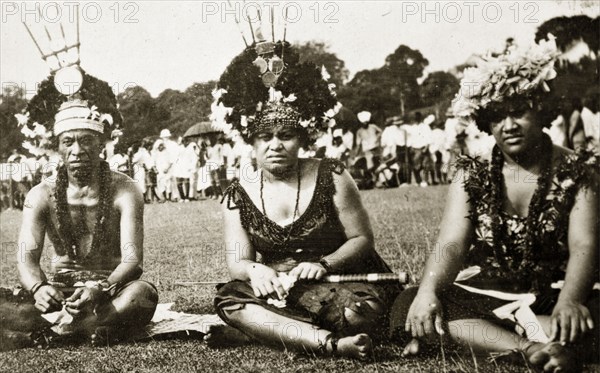 Samoans at a 'meke' dance. Samoan men in traditional costume at a 'meke' in Albert Park. They wear elaborate headdresses made from flowers and their necks are adorned with garlands of flowers (leis). Suva, Fiji, 21-27 May 1924. Suva, Viti Levu, Fiji, Pacific Ocean, Oceania.