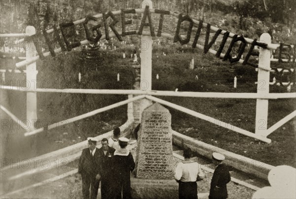 The Great Divide'. Uniformed naval personnel stand beside a stone marker indicating the division between the provinces of Alberta and British Colombia. Canada, 21 June-4 July 1924. Canada, North America, North America .