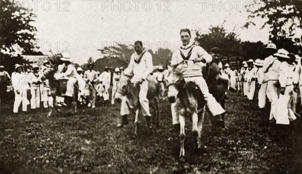 Donkey derby winning post. Uniformed sailors in the British Special Service Squadron entertain their shipmates as they ride donkeys in a derby race. Chapelton, Jamaica, 26-30 July 1924. Chapelton, Clarendon, Jamaica, Caribbean, North America .