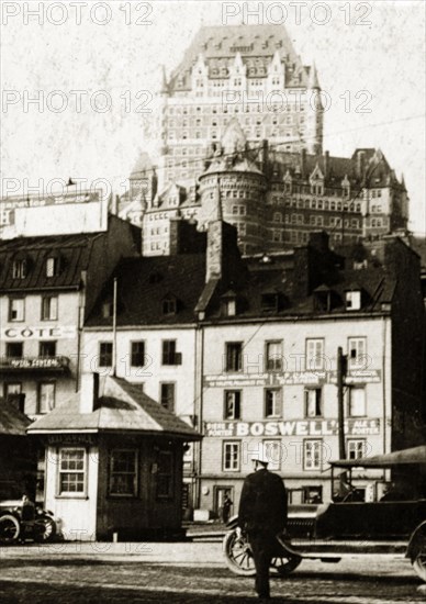 Old town, Quebec. View of shopfronts in the old town with the Chateau Frontenac Hotel visible in the distance. Quebec, Canada, 18 August-2 September 1924. Quebec, Quebec, Canada, North America, North America .