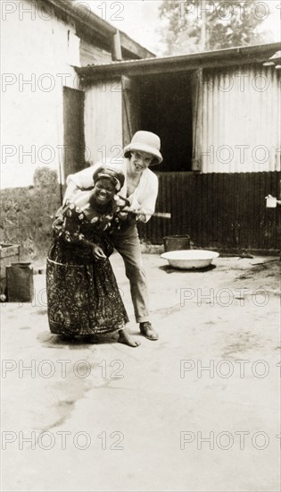Mr Tamlin grappling. Mr Alfred Tamlin tickles an African woman. Western Africa, circa 1920., Western Africa, Africa.