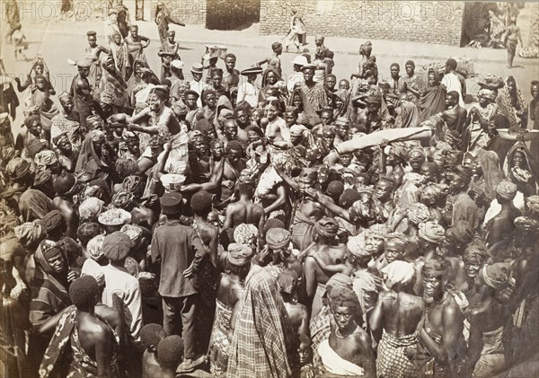 Chief's funeral in Accra. An overhead shot of a mourning party gathered in the street for a deceased chief. Accra, Gold Coast (Ghana), circa 1920. Accra, East (Ghana), Ghana, Western Africa, Africa.