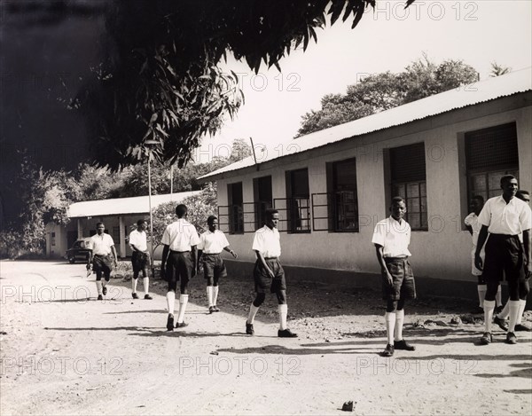 Tanganyikan students outside college. Official publicity shot for the Tanganyikan government. Young men in uniform outside a college building. Tanganyika Territory (Tanzania), circa 1950. Tanzania, Eastern Africa, Africa.
