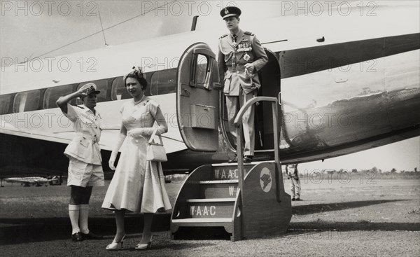 Queen Elizabeth II visits Nigeria, 1956. Queen Elizabeth II and Prince Philip, Duke of Edinburgh, disembark from an aeroplane upon arrival at Enugu, during their royal tour of Nigeria between 28 January and 16 February 1956. Enugu, Anambra State, Nigeria, circa January 1956. Enugu, Anambra, Nigeria, Western Africa, Africa.