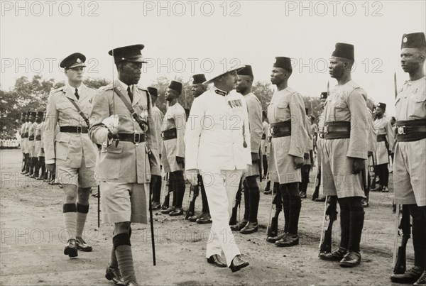 Inspection of the King's African Rifles. A European military officer, possibly a colonial Governor, inspects a regiment of the King's African Rifles. Probably Central Africa, circa 1955., Central Africa, Africa.