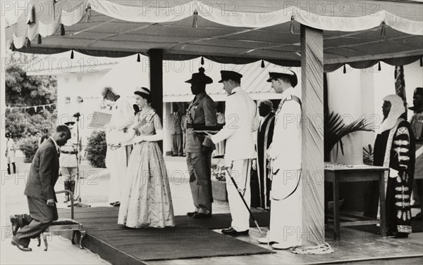 Queen Elizabeth II confers a knighthood. Queen Elizabeth II confers a knighthood on Dr Francis Ibiam of the Church of Scotland Mission, in honour of his contribution to medical services. The Queen undertook a royal tour of Nigeria with her husband, Prince Philip, Duke of Edinburgh, between 28 January and 16 February 1956. Nigeria, circa January 1956. Nigeria, Western Africa, Africa.