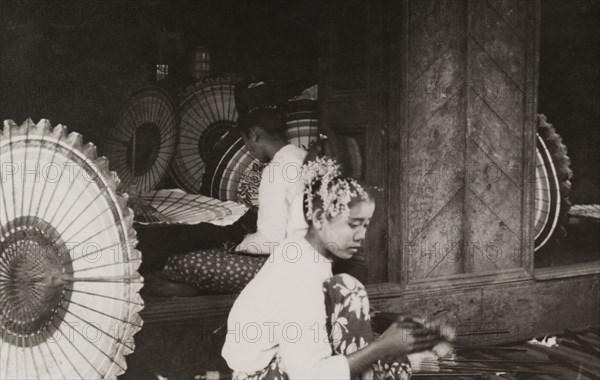 Burmese parasol workshop. Two Burmese craftswomen work inside a parasol workshop. Burma (Myanmar), circa 1925. Burma (Myanmar), South East Asia, Asia.