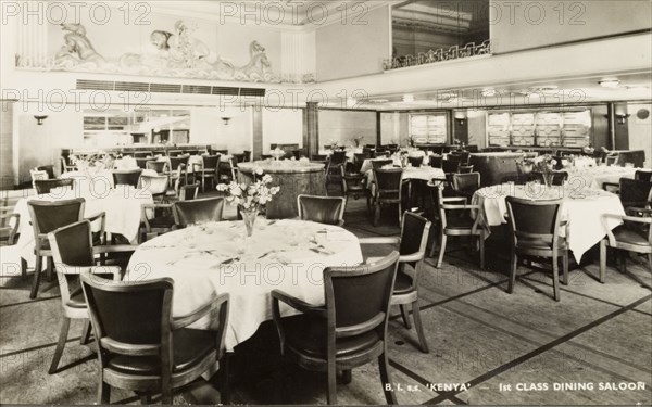Dining saloon aboard S.S. Kenya. Interior of the first class dining saloon aboard S.S. Kenya, a passenger liner that entered service in 1951, operating from London to East Africa. Location unknown, circa 1952.