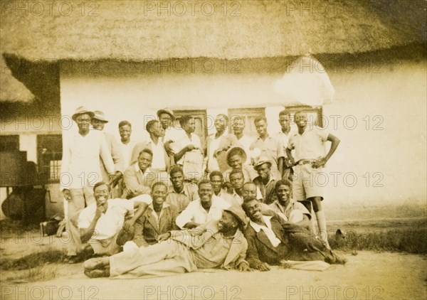 Chalimbana Training College. Mature male students from the Chalimbana (teacher) Training College pose for a group portrait outside a thatched building. This particular group were married students receiving art training. Lusaka, Northern Rhodesia (Zambia), circa 1952., Lusaka, Zambia, Southern Africa, Africa.