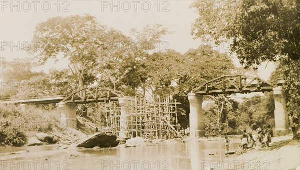 The Ishua to Ibillo bridge. Scaffolding straddles a river beneath an unfinished section of the Ishua to Ibillo road bridge. Ondo, Nigeria, circa 1950., Ondo, Nigeria, Western Africa, Africa.