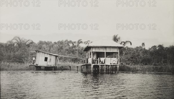 Oropo rest house. Oropo rest house stands isolated on the edge of Mahin Lagoon, built on stilts and accessible only by canoe. Rest houses such as this would have accommodated colonial officers as they toured the vast areas of their jurisdiction: most were easily accessible by road. Ondo, Nigeria, circa 1950., Ondo, Nigeria, Western Africa, Africa.