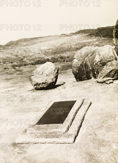 The grave of Cecil Rhodes. The grave of Cecil John Rhodes (1853-1902), located on a hilltop in the Matopos Hills. Rhodes was the effective founder of the state of Rhodesia in southern Africa, which was named after him. Bulawayo, Southern Rhodesia (Zimbabwe), circa 1930. Bulawayo, Zimbabwe, Southern Africa, Africa.