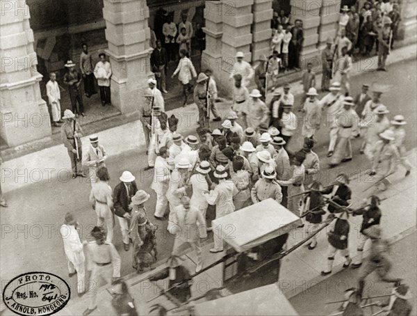 Assassination attempt on Sir Frances Henry May. Commotion on Pedder Street, moments after an assassination attempt on Hong Kong's new Governor, Sir Frances Henry May (1860-1922). May was uninjured in the shooting, which took place as he travelled to Government House by sedan chair. Hong Kong, China, 7 May 1912. Hong Kong, Hong Kong, China, People's Republic of, Eastern Asia, Asia.