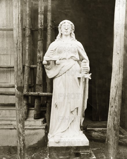 The Statue of Justice. The Statue of Justice stands outside the Law Courts. Measuring 2.7 metres in height, it was carved in 1908 from a single block of granite by a Chinese stone mason named Lau Kiu. Hong Kong, China, circa 1908. Hong Kong, Hong Kong, China, People's Republic of, Eastern Asia, Asia.