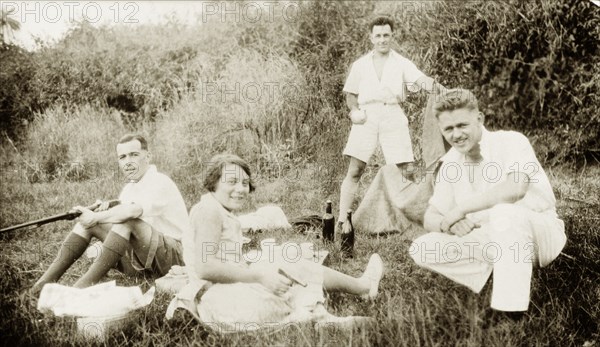 Dr Greta Lowe-Jellicoe enjoys a picnic. Three European men identified as 'Staunton, Ridley and Orrell' enjoy a countryside picnic with Dr Greta Lowe-Jellicoe, a medical missionary based in Nigeria between 1926 and 1935. Probably Abeokuta, Ogun State, Nigeria, 1929. Abeokuta, Ogun, Nigeria, Western Africa, Africa.