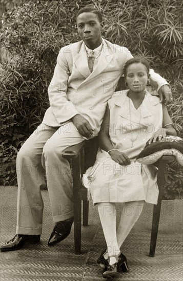 A married Nigerian couple. Portrait of a married Nigerian couple, dressed in fashionable Western-style clothing. The woman pictured is identified as Comfort Ayename, a senior nurse at the Sacred Heart Hospital in Abeokuta. Abeokuta, Ogun State, Nigeria, circa 1929. Abeokuta, Ogun, Nigeria, Western Africa, Africa.