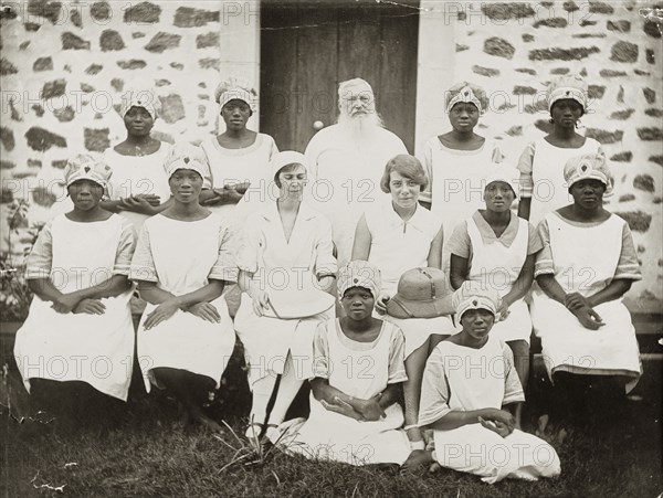 Medical staff at the Sacred Heart Hospital. Nigerian and European medical staff pose for a group portrait outside the Sacred Heart Hospital in Abeokuta. The European woman on the right is identified as Dr Greta Lowe-Jellicoe, a medical missionary based in Nigeria between 1926 and 1935. The Nigerian woman to her left is Comfort Ayename, a senior nurse at the hospital. Abeokuta, Ogun State, Nigeria, circa 1929. Abeokuta, Ogun, Nigeria, Western Africa, Africa.