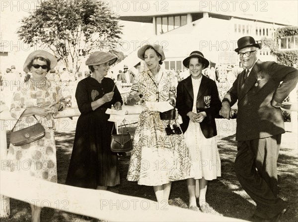 A day at the races, Nairobi. Mr and Mrs Pughe enjoy a day at Nairobi horse races with their daughter, Karoline, and two companions. Nairobi, Kenya, circa 1956. Nairobi, Nairobi Area, Kenya, Eastern Africa, Africa.