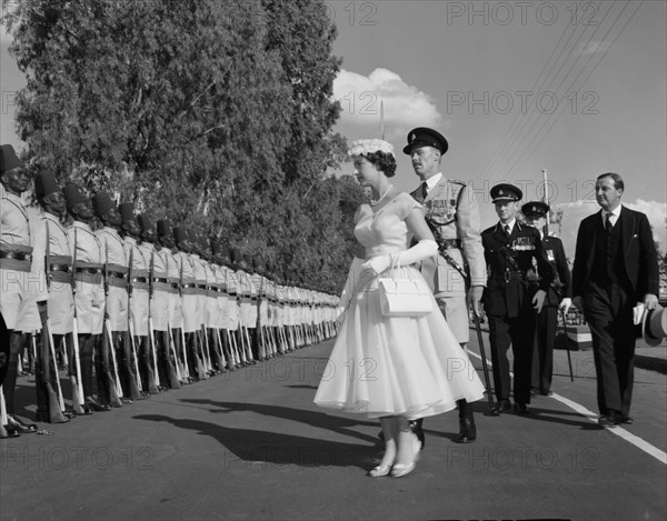 Princess Margaret inspects a Guard of Honour. Princess Margaret, accompanied by European military officers, inspects a Guard of Honour consisting of uniformed African soldiers outside the Royal Technical College. Nairobi, Kenya, 23 October 1956. Nairobi, Nairobi Area, Kenya, Eastern Africa, Africa.