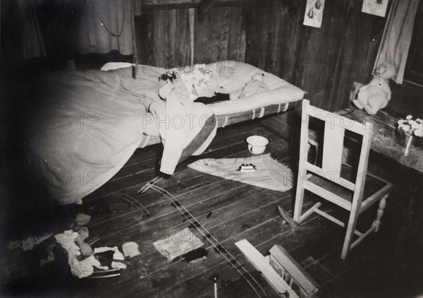 Michael Ruck's bedroom. A pool of blood stains a dishevelled bed in the toy-filled room of Michael Ruck, a six year old child murdered by Mau Mau fighters. Kenya, January 1953. Kenya, Eastern Africa, Africa.